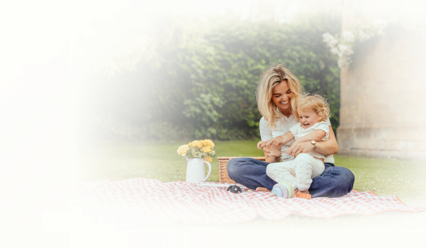 A parent and child sharing a picnic moment